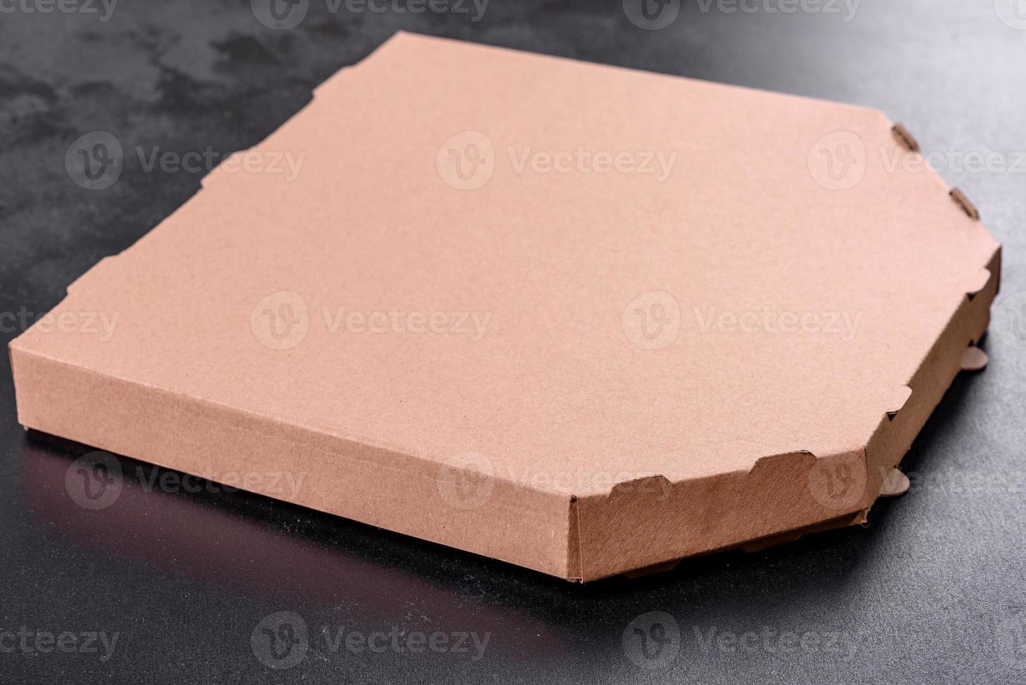 Cardboard brown box of square shape for transportation and delivery of pizza photo