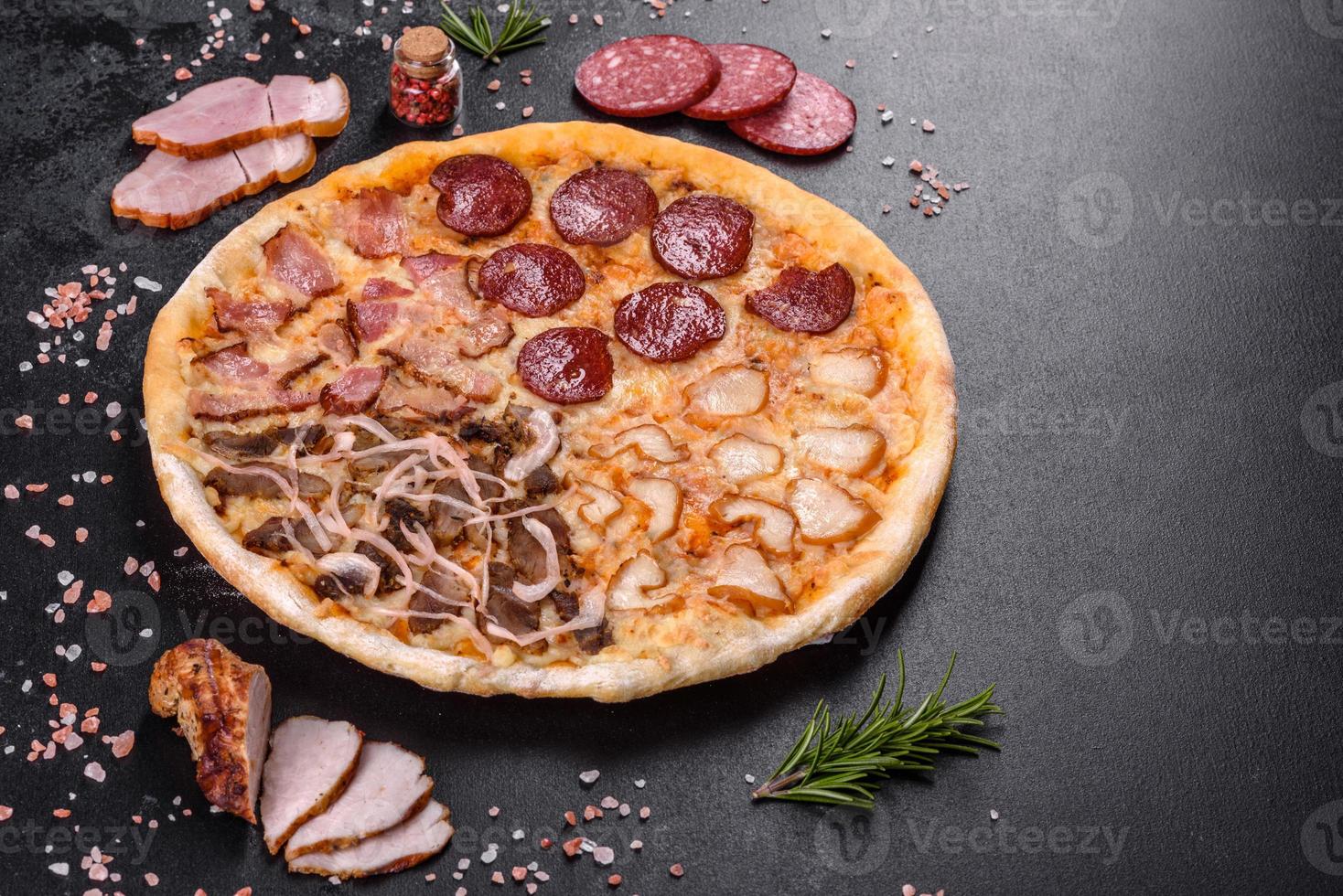 Fresh delicious pizza made in a hearth oven with four types of meat and sausage photo