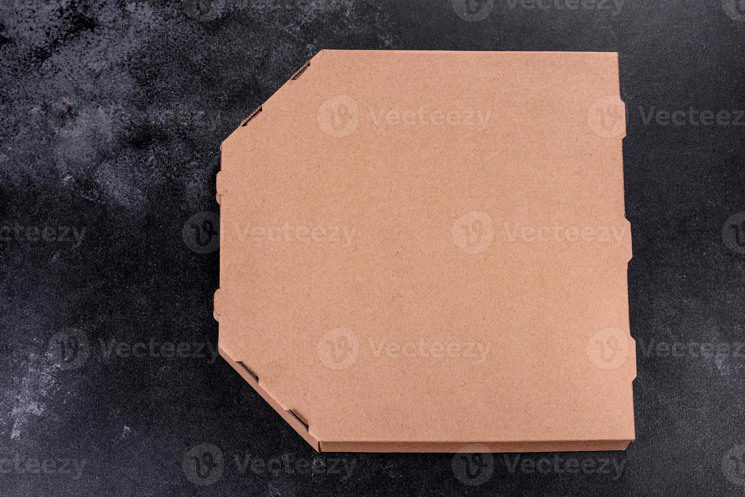 Cardboard brown box of square shape for transportation and delivery of pizza photo