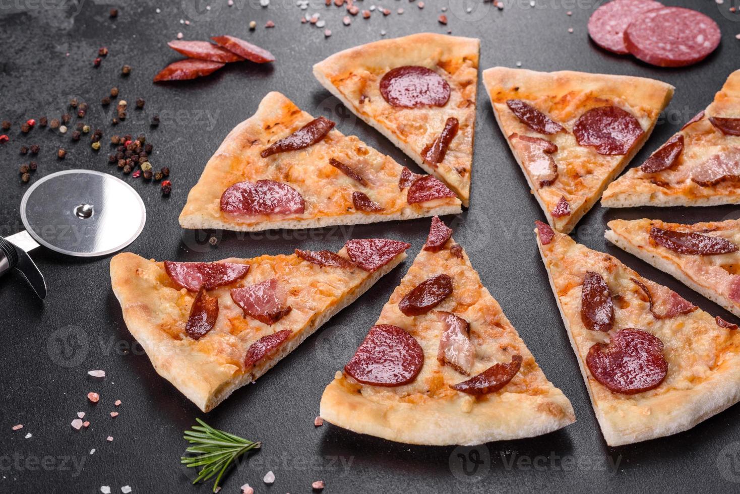 Fresh delicious pizza made in a hearth oven with four types of meat and sausage photo