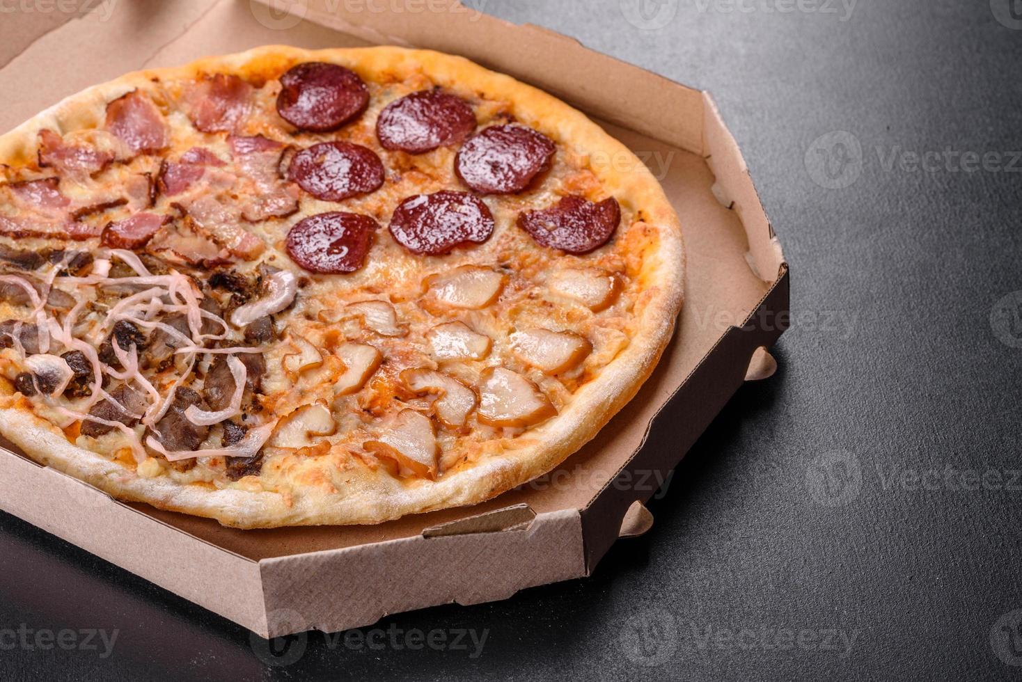 Fresh delicious pizza made in a hearth oven with four types of meat and sausage photo