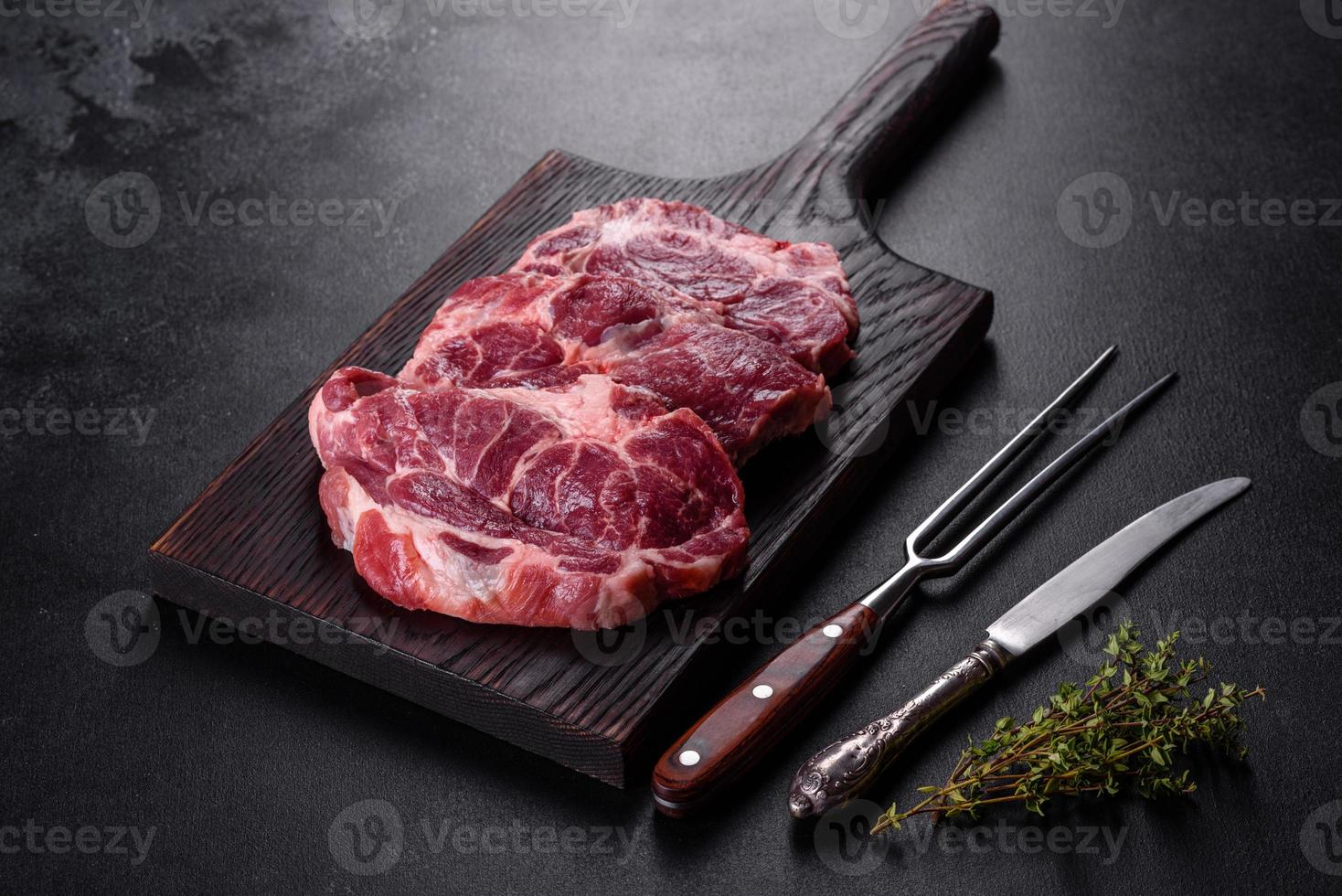 Fresh raw beef meat to make delicious juicy steak with spices and herbs photo