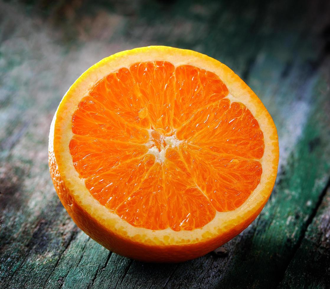 Orange slice on old wood photo