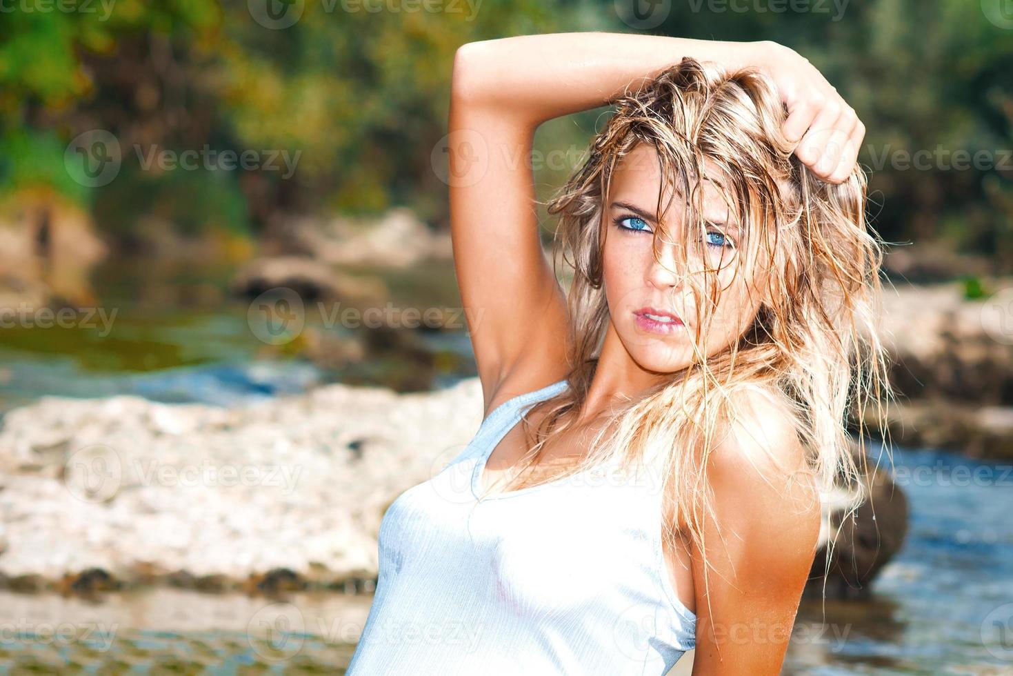 Beautiful wild wild style blonde woman with blue eyes with wet hair disheveled photo