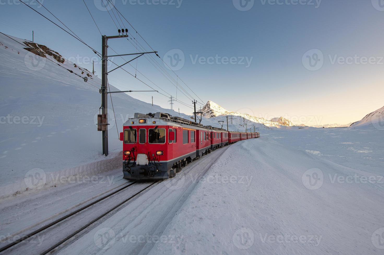 Red train during the passage of the Bernina pass areas photo