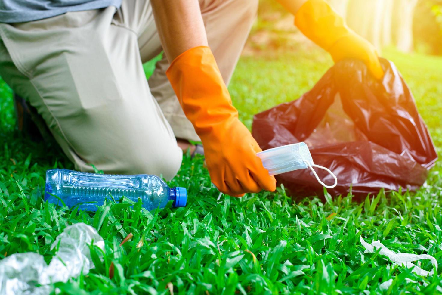 Volunteer man collecting trash photo