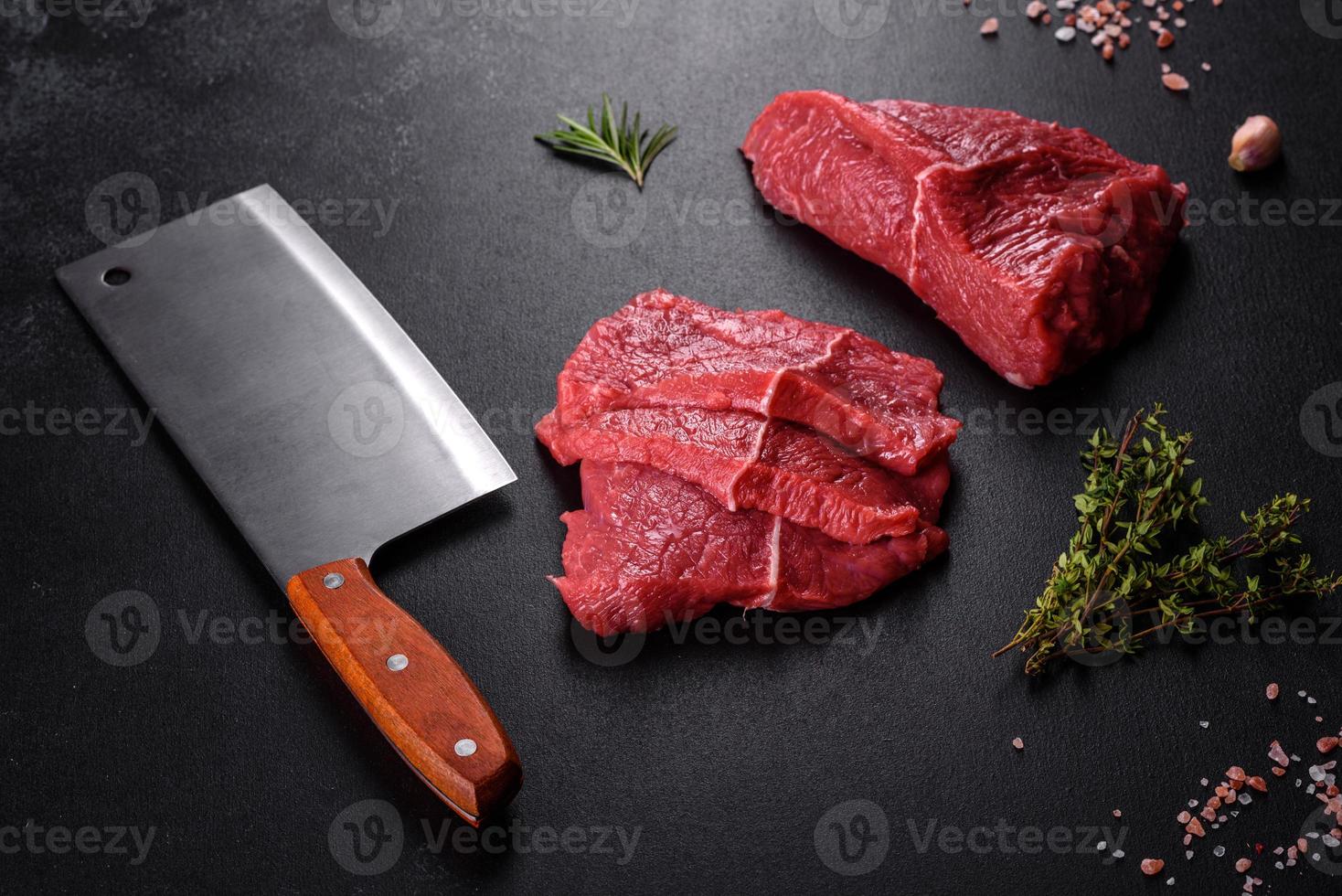 Fresh raw beef meat to make delicious juicy steak with spices and herbs photo