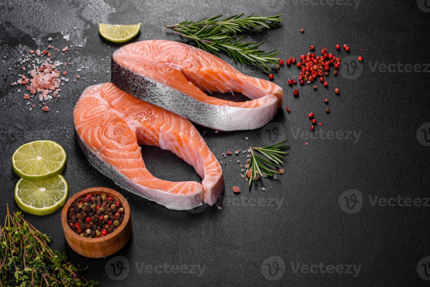 Fresh raw salmon steak with spices and herbs prepared for grilled baking photo