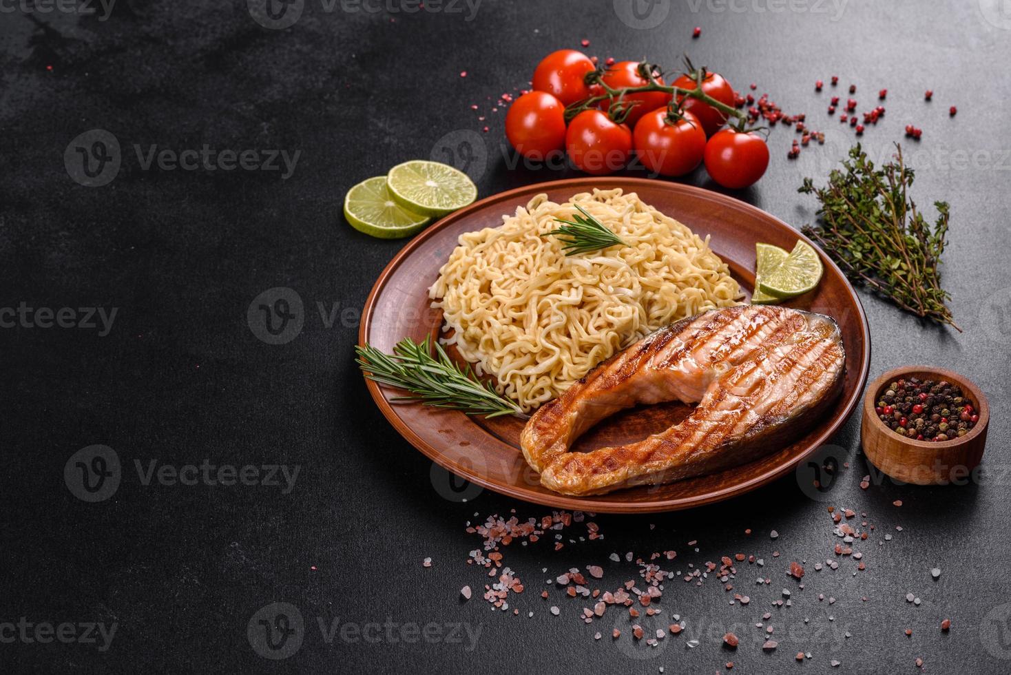 Fresh cooked delicious salmon steak with spices and herbs baked on a grill photo