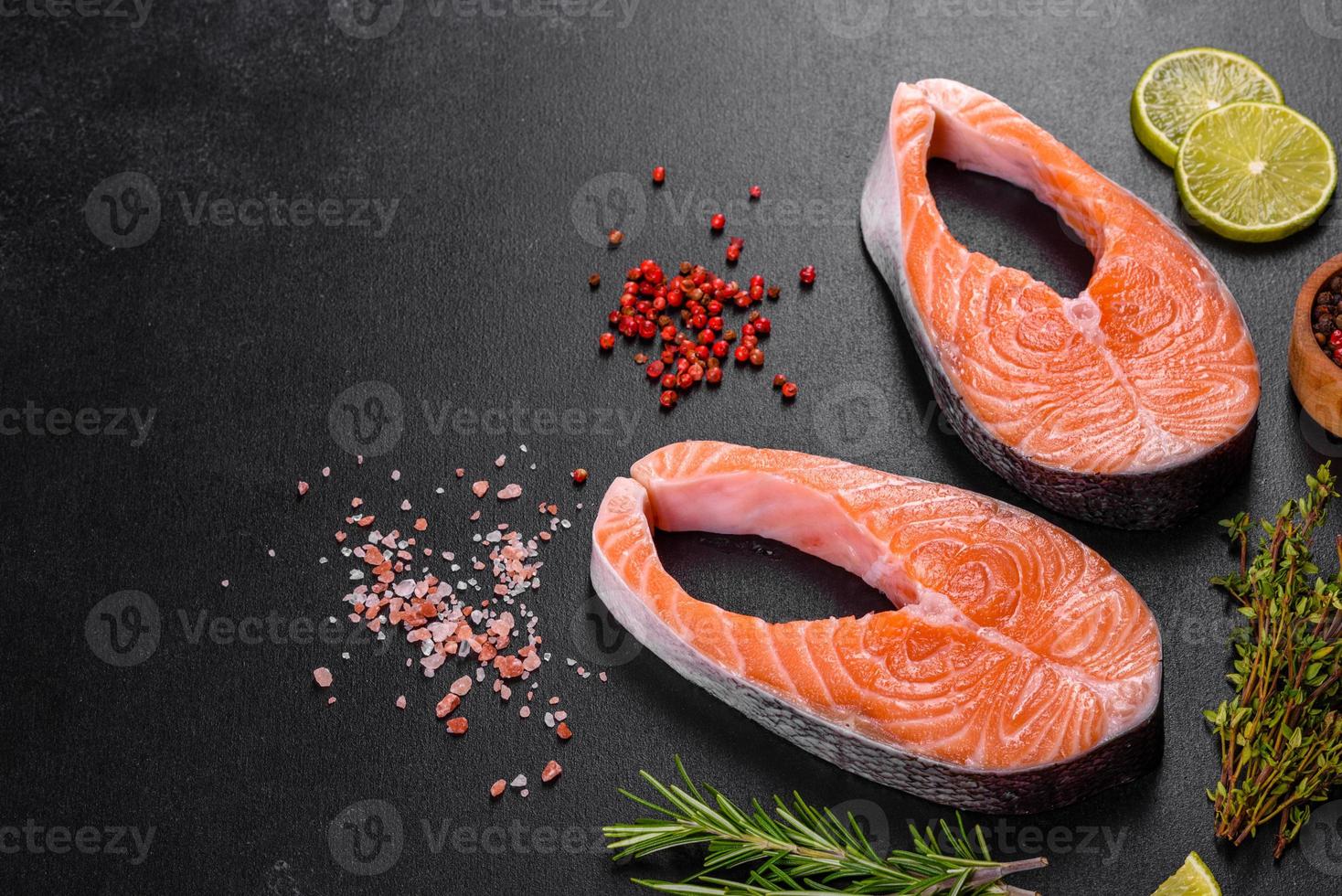 Fresh raw salmon steak with spices and herbs prepared for grilled baking photo