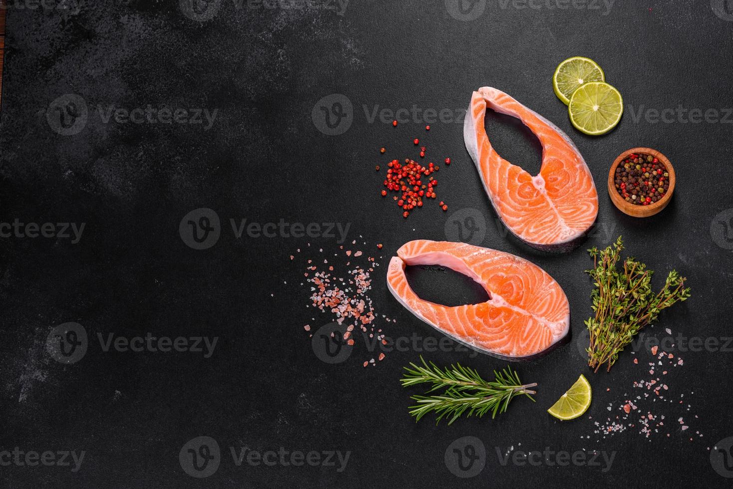 Fresh raw salmon steak with spices and herbs prepared for grilled baking photo