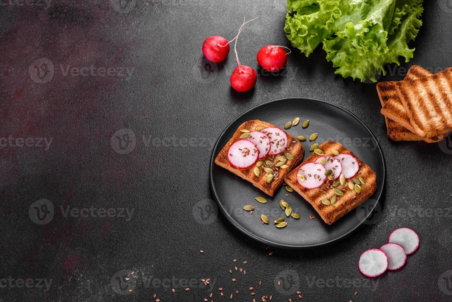 Delicious crisp sandwich with toast, radish, pumpkin seeds and flax seeds photo