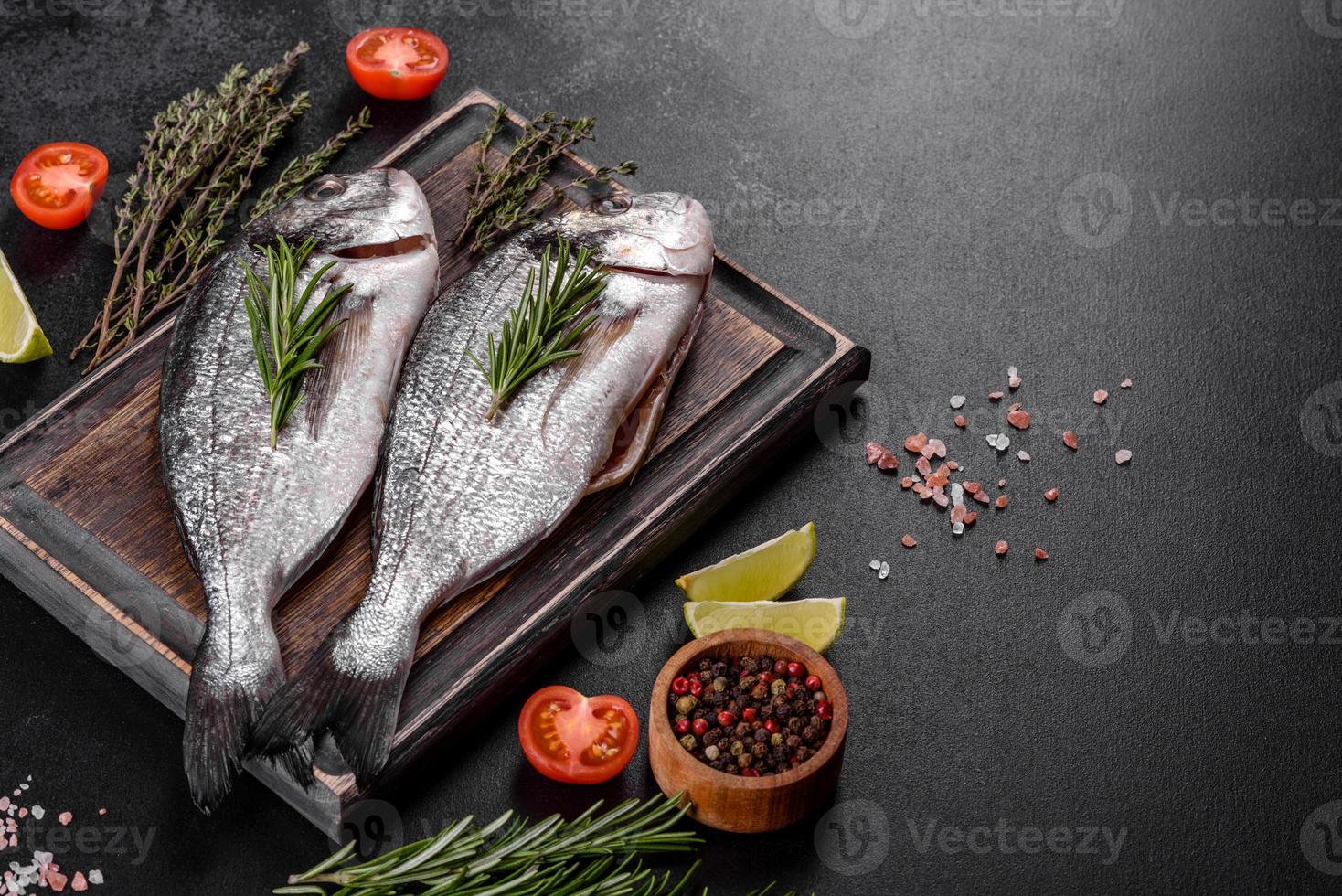 Raw dorado fish with spices cooking on cutting board. Fresh fish dorado photo