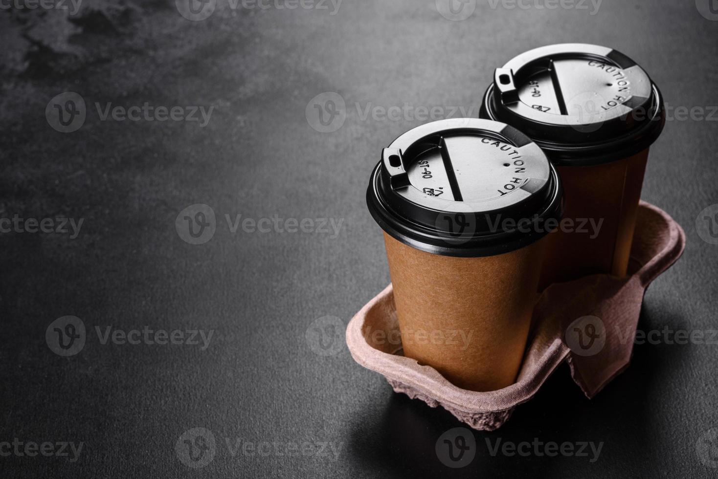 Disposable dishes made of environmentally friendly brown cardboard on a dark background photo