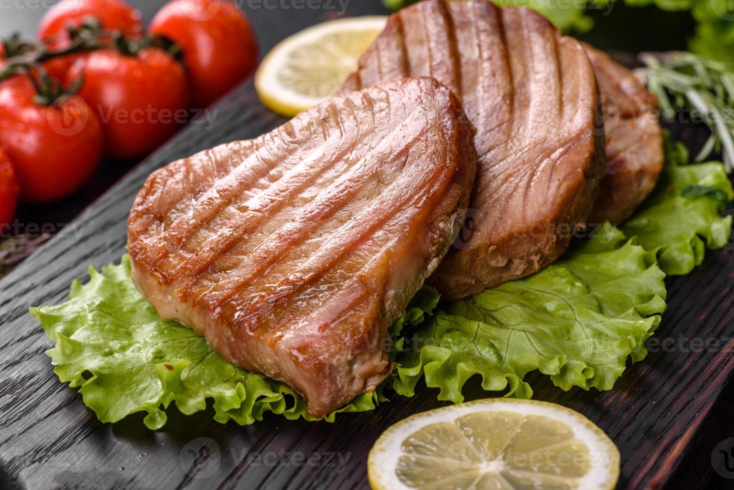 Delicioso y jugoso filete de atún a la parrilla con especias y hierbas. foto