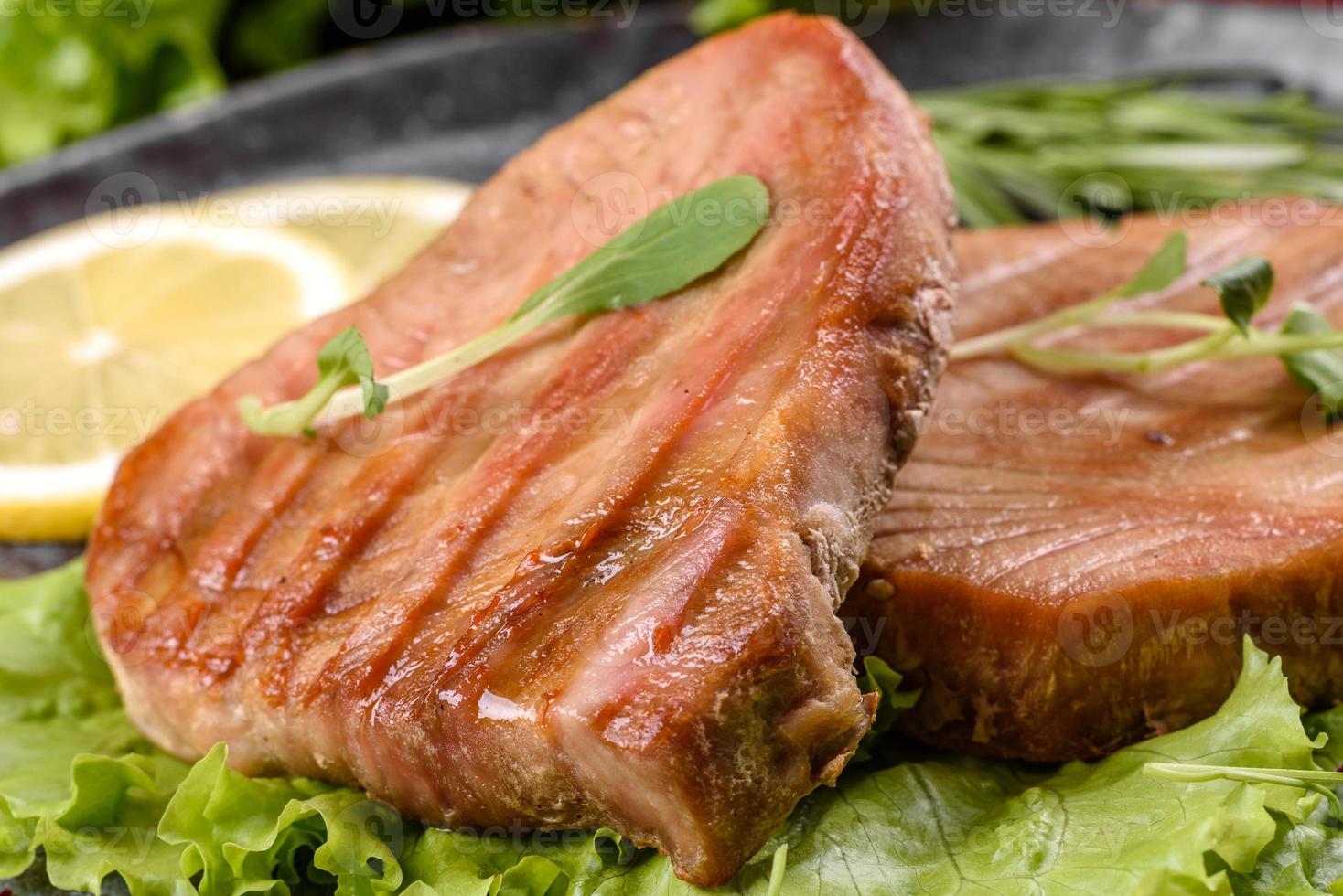 Delicious juicy tuna steak grilled with spices and herbs photo