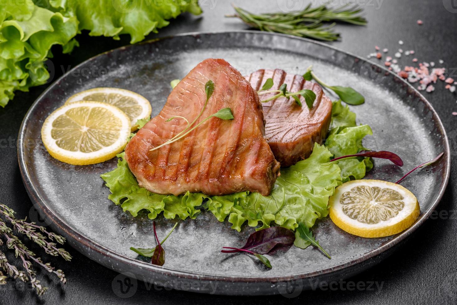 Delicioso y jugoso filete de atún a la parrilla con especias y hierbas. foto