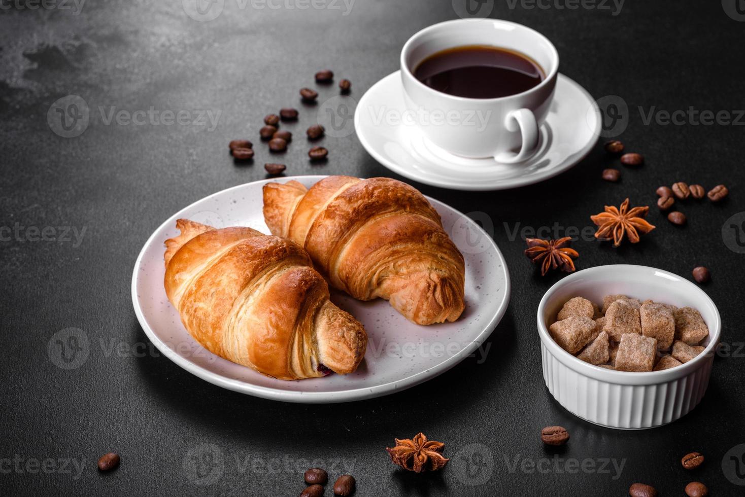 Fresh crisp delicious French croissant with a cup of fragrant coffee photo