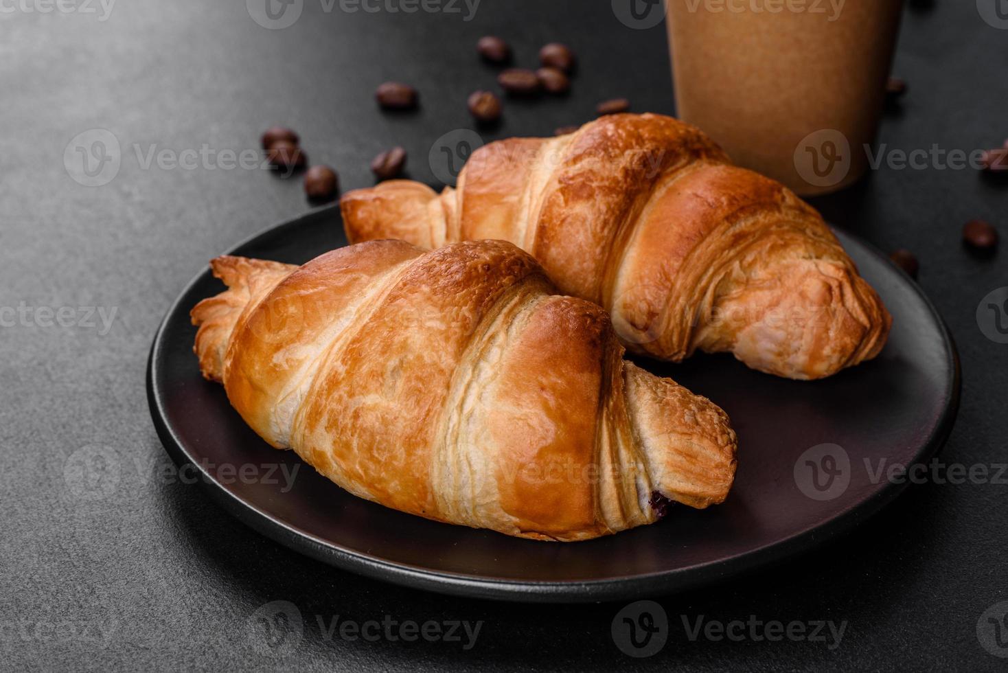 delicioso croissant francés fresco y crujiente con una taza de café aromático foto