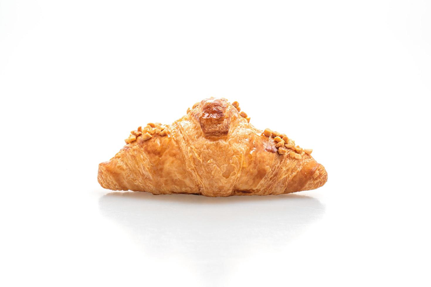 Fresh croissant with peanut on plate photo