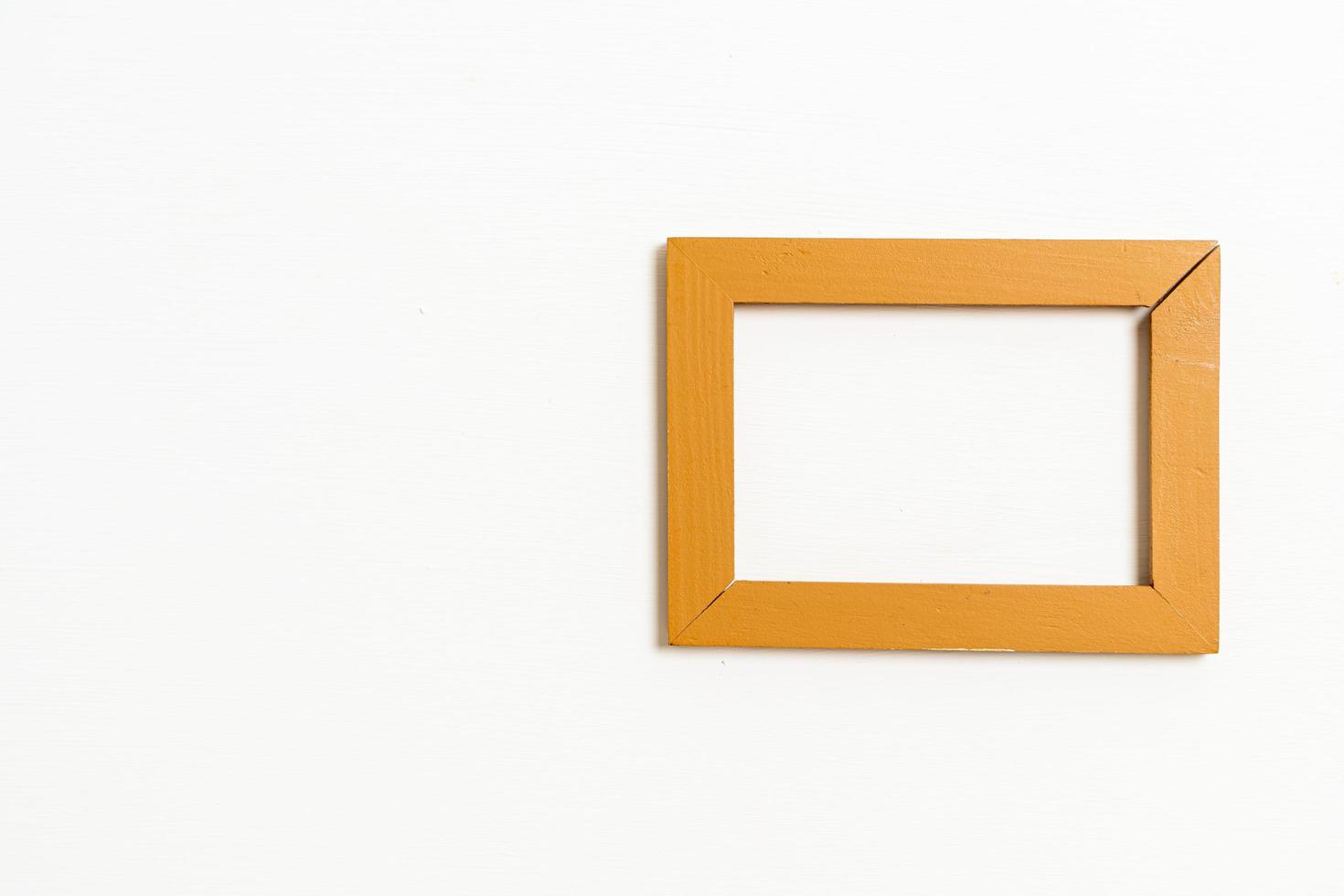 Empty picture frame on white wall background with copy space photo