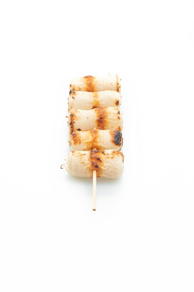 Grilled tube-shaped fish paste cake skewer isolated on white background photo