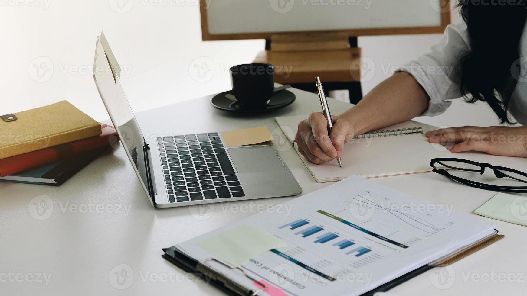 Woman writing in notebook photo