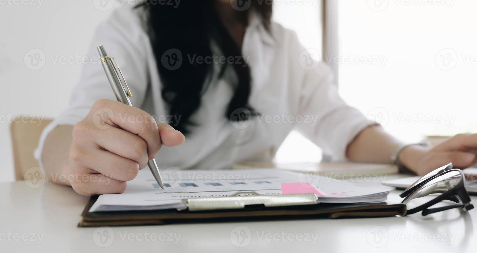 Close up of Business woman investment consultant analysis company annual financial report balance sheet statement working with documents graphs. Concept picture of economy, marketing photo