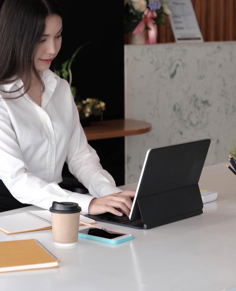 retrato, de, joven, mujer de negocios, utilizar la computadora portátil foto