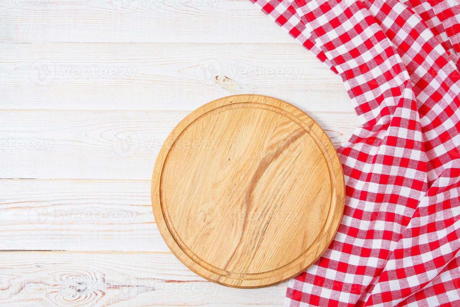 Top view wrinkled red tablecloth and plank on wooden table, mock up photo