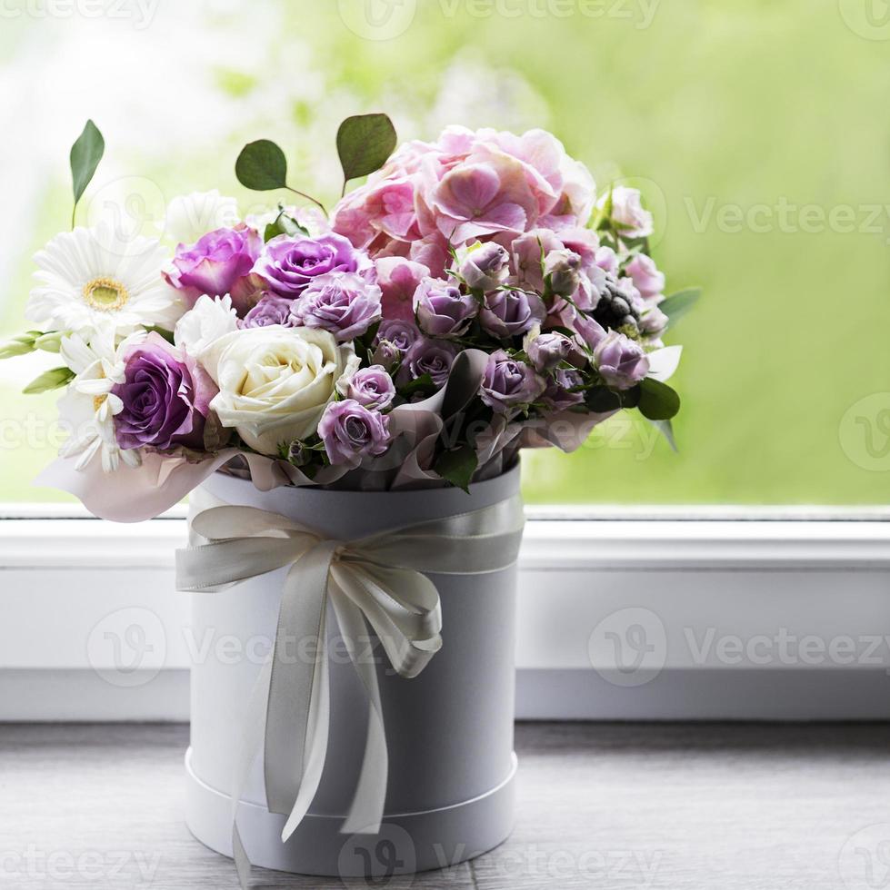 Beautiful flowers in a white round box photo