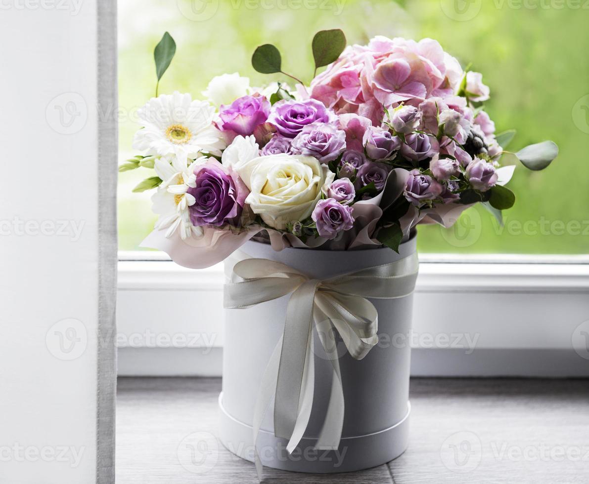 Beautiful flowers in a white round box photo