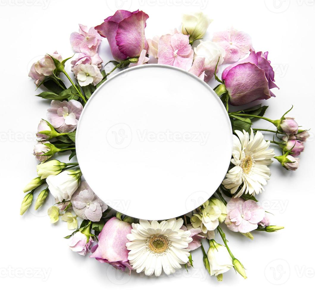 Pink flowers in round frame with white circle for text photo