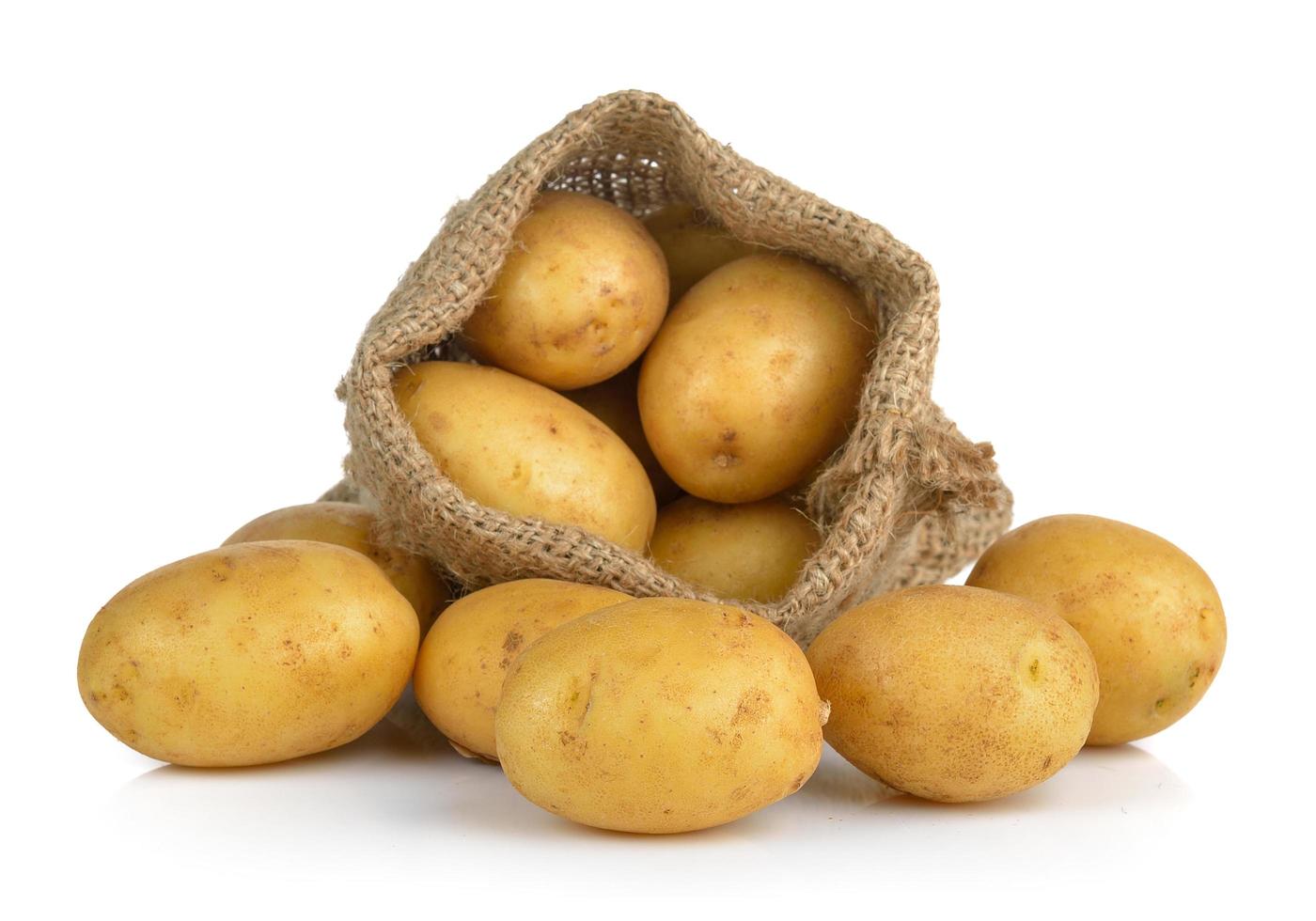 Potato in the sack isolated on white background photo