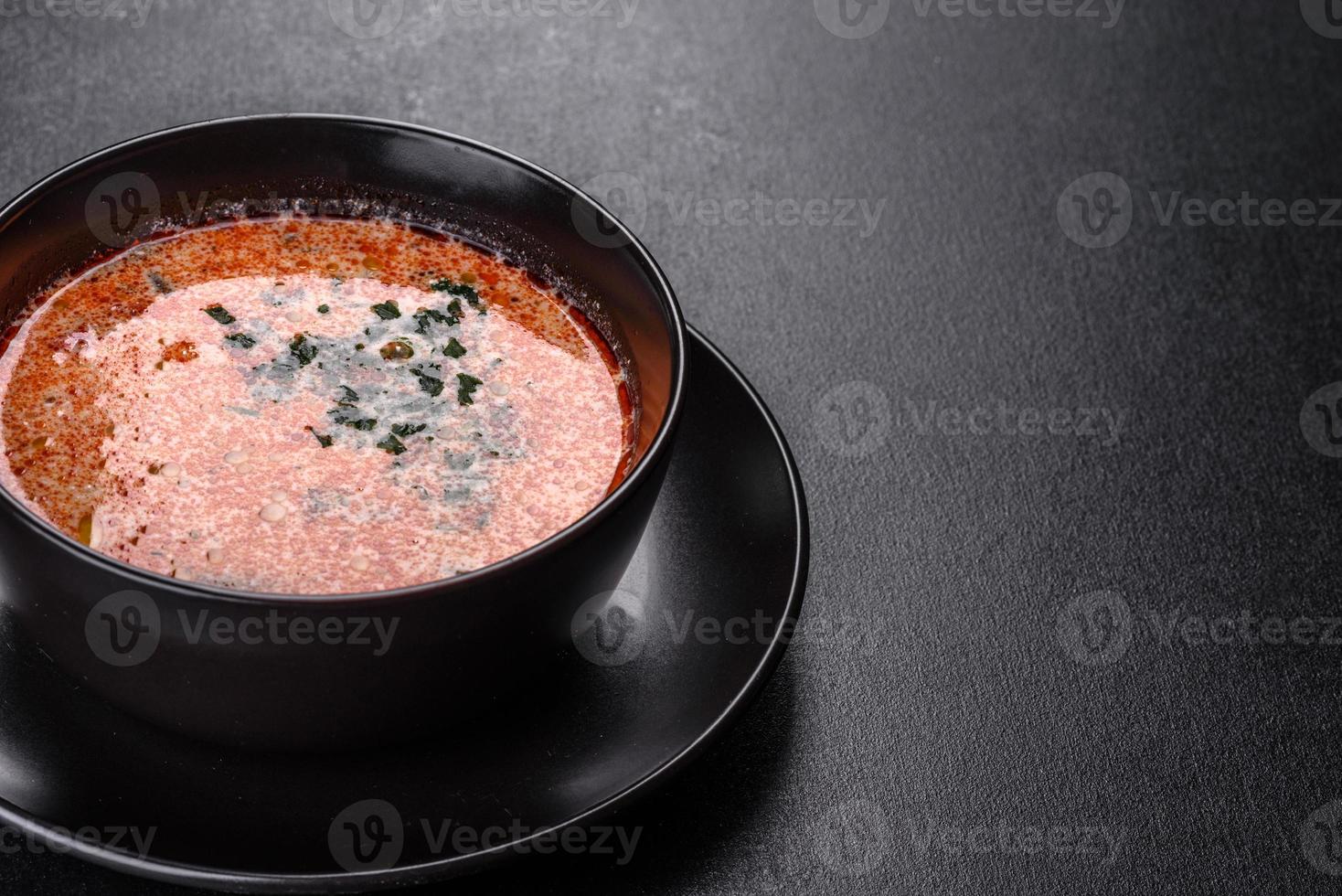 Tasty fresh spicy Malaysia soup tom yam with tomato photo