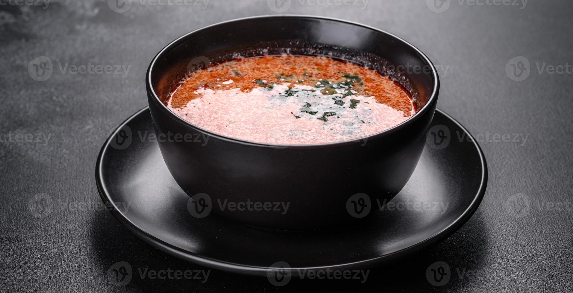 Tasty fresh spicy Malaysia soup tom yam with tomato photo