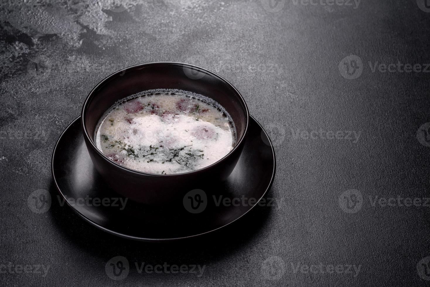 Cheese soup with fried sausages and herbs. Tasty cream cheese soup photo