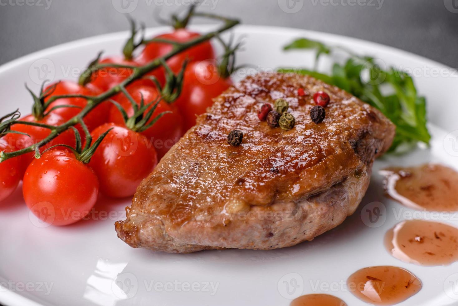 Baked duck breast with herbs and spices on a dark concrete background photo