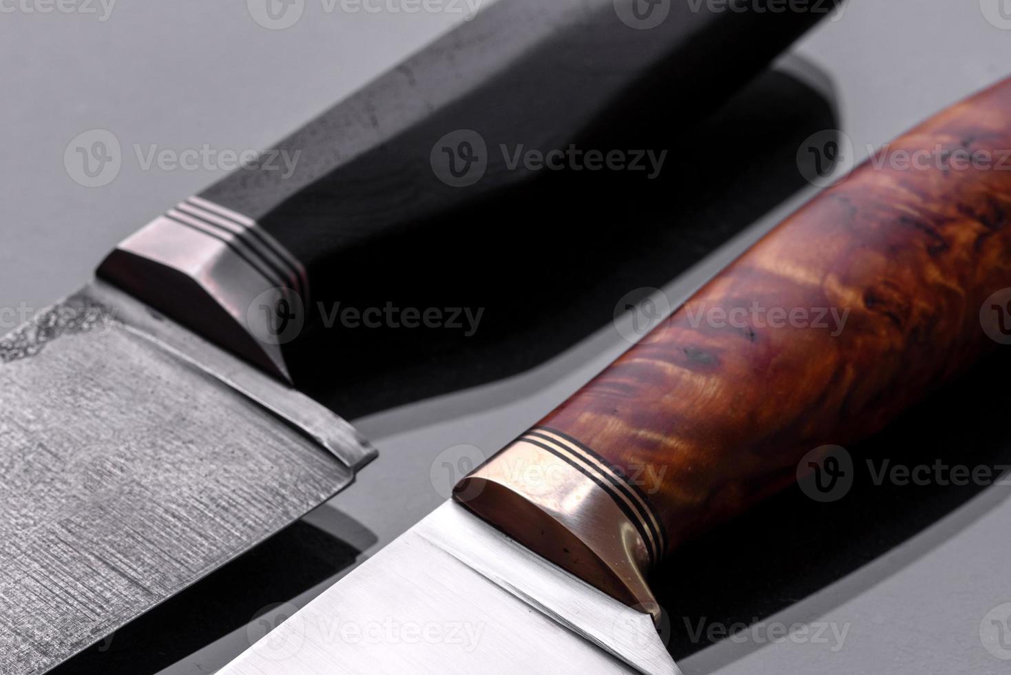 A large handmade hunting knife lying on a dark background photo