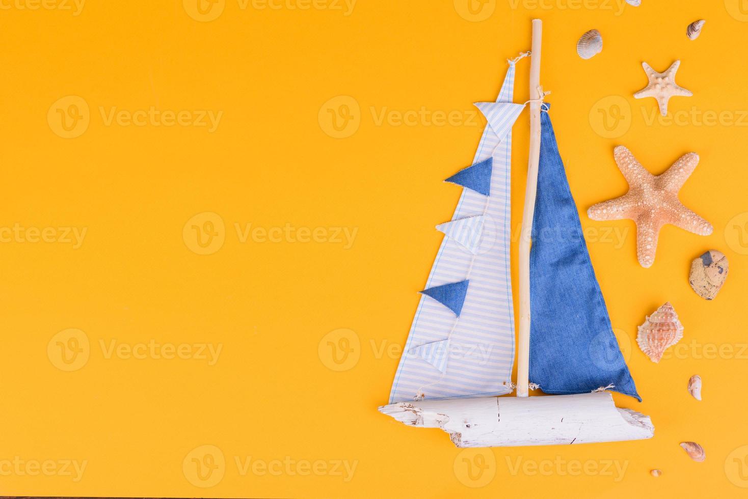 Glasses and hat with shells and sea stars on a colored background photo