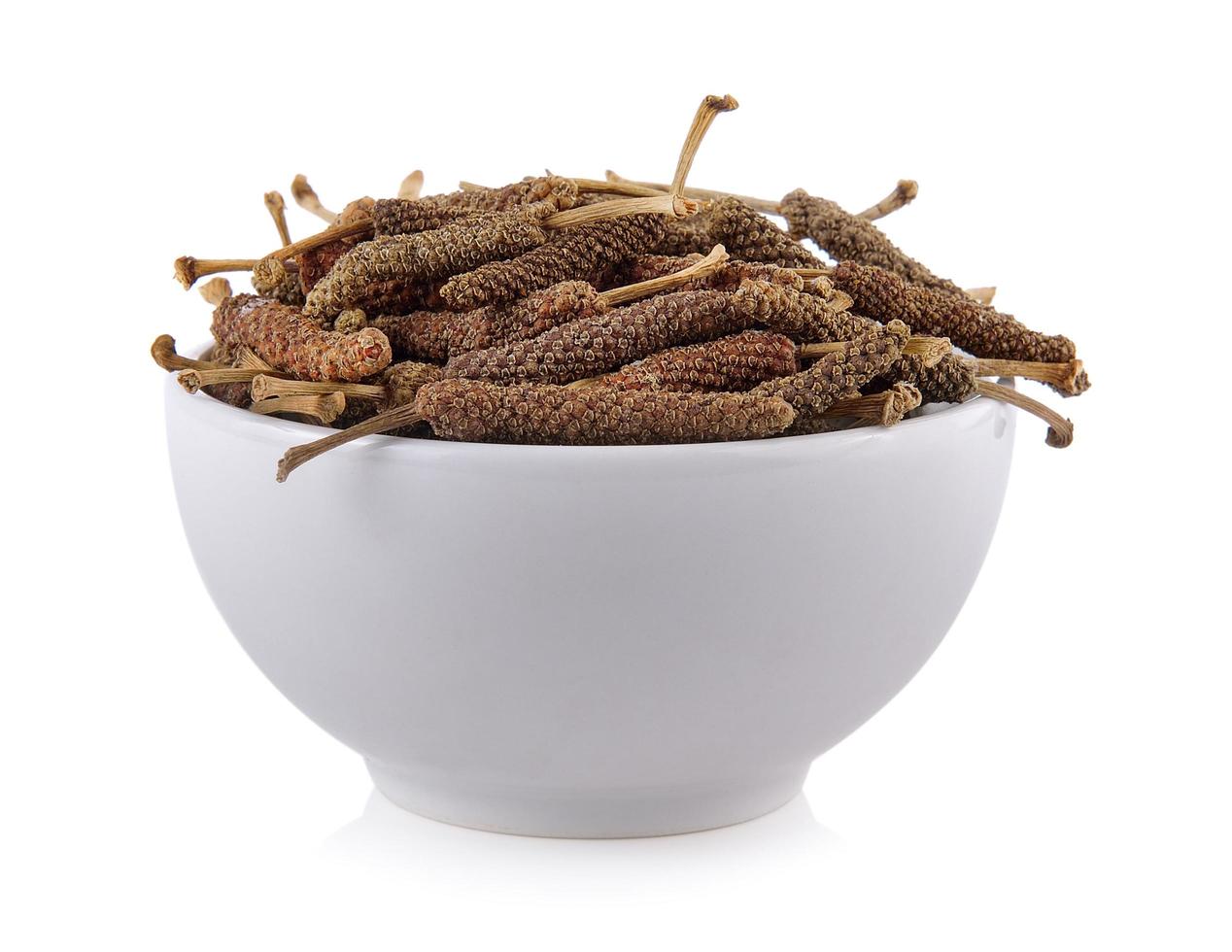 Long pepper in the bowl on white background photo