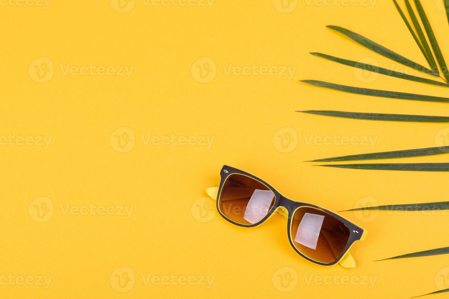 Glasses and hat with shells and sea stars on a colored background photo