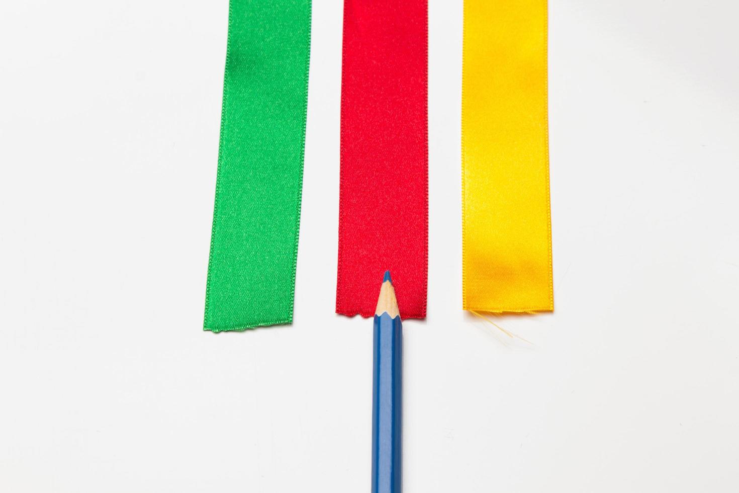 Coloured pencils wrapped in a green ribbon photo