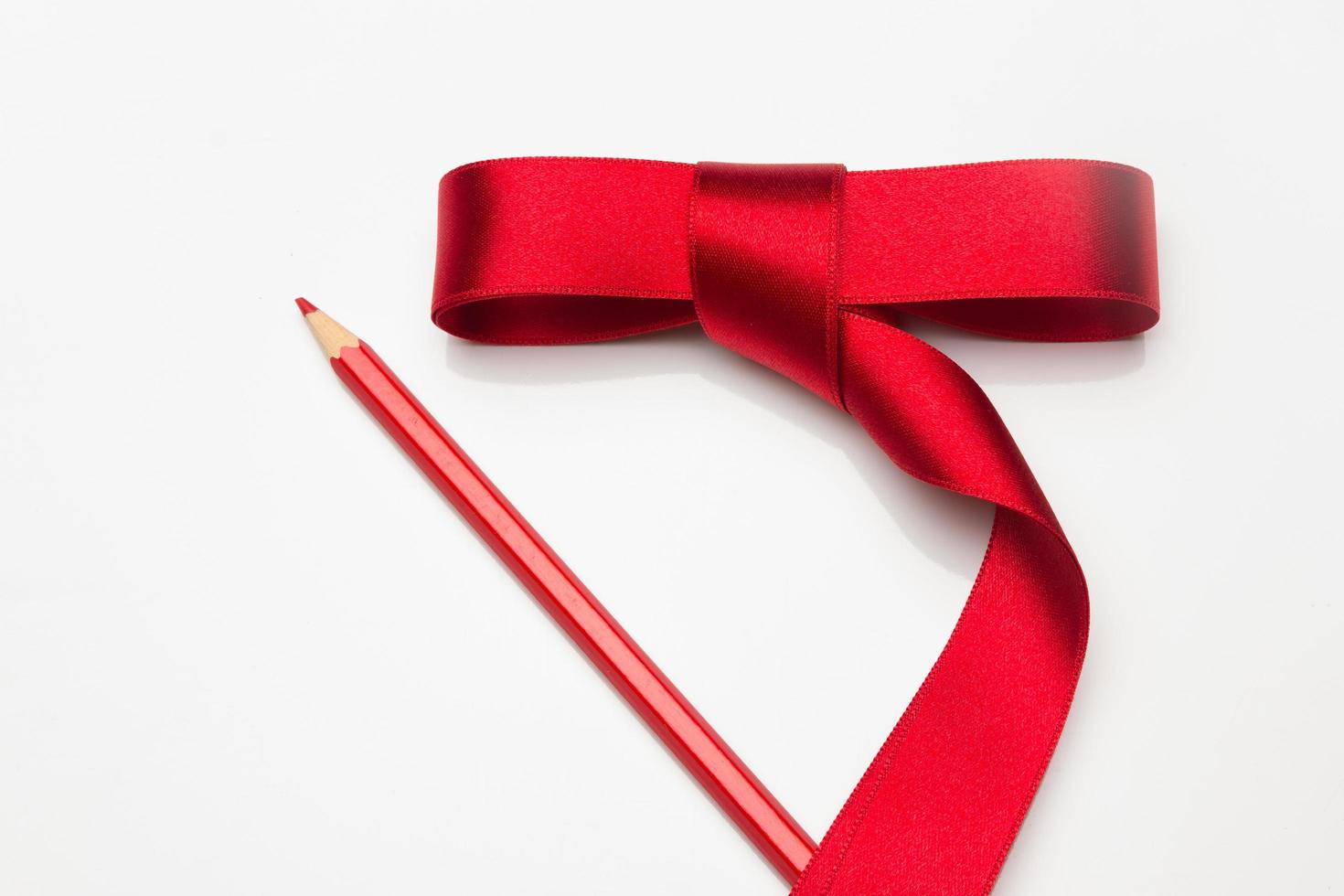 Coloured pencils wrapped in a green ribbon photo