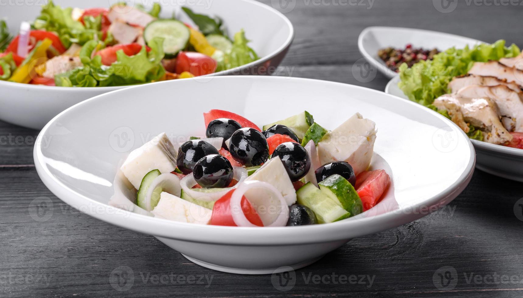 deliciosa ensalada griega fresca con tomate, pepino, cebolla y aceitunas con aceite de oliva foto