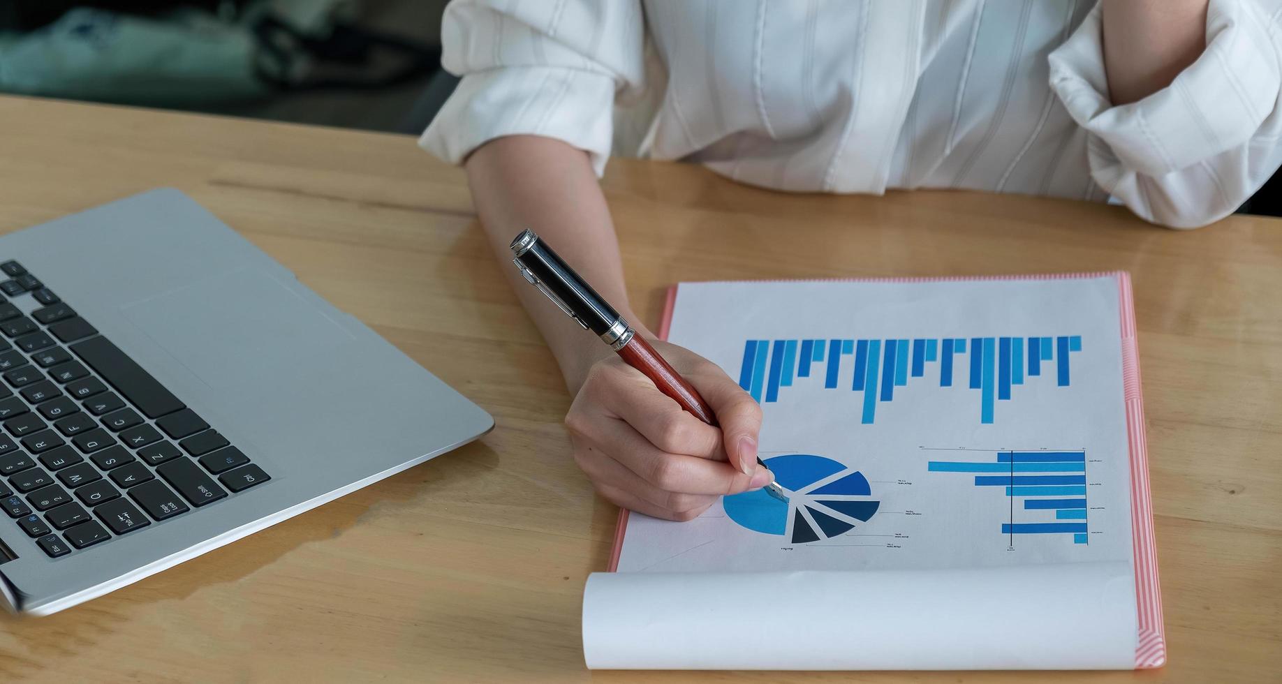 Businesswoman or accountant holding pen, working in the office photo