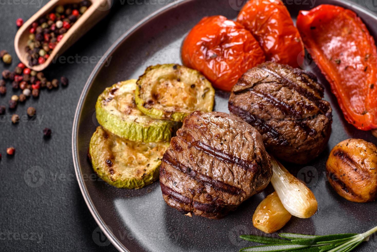 Tasty baked beef medallion with vegetables, mushrooms and spices photo