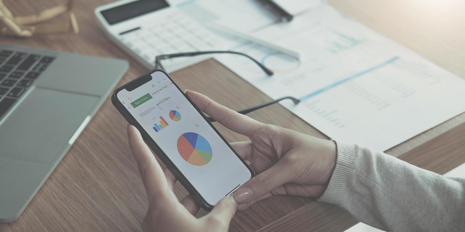 Businesswoman analyzing stock market on an iPhone photo