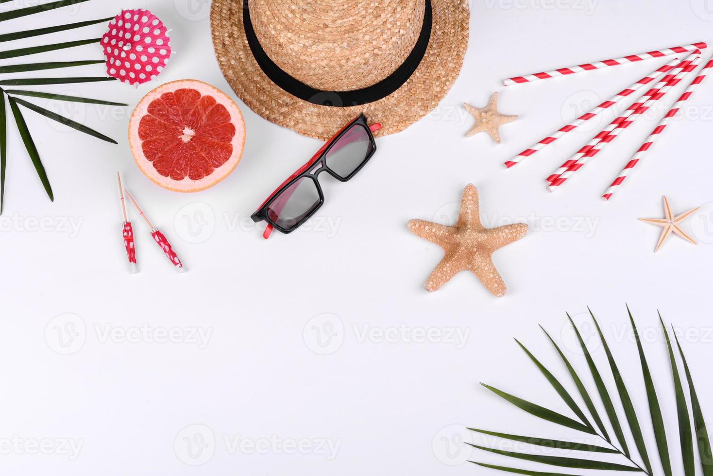 Beach accessories, glasses and hat with shells and sea stars on a colored background photo