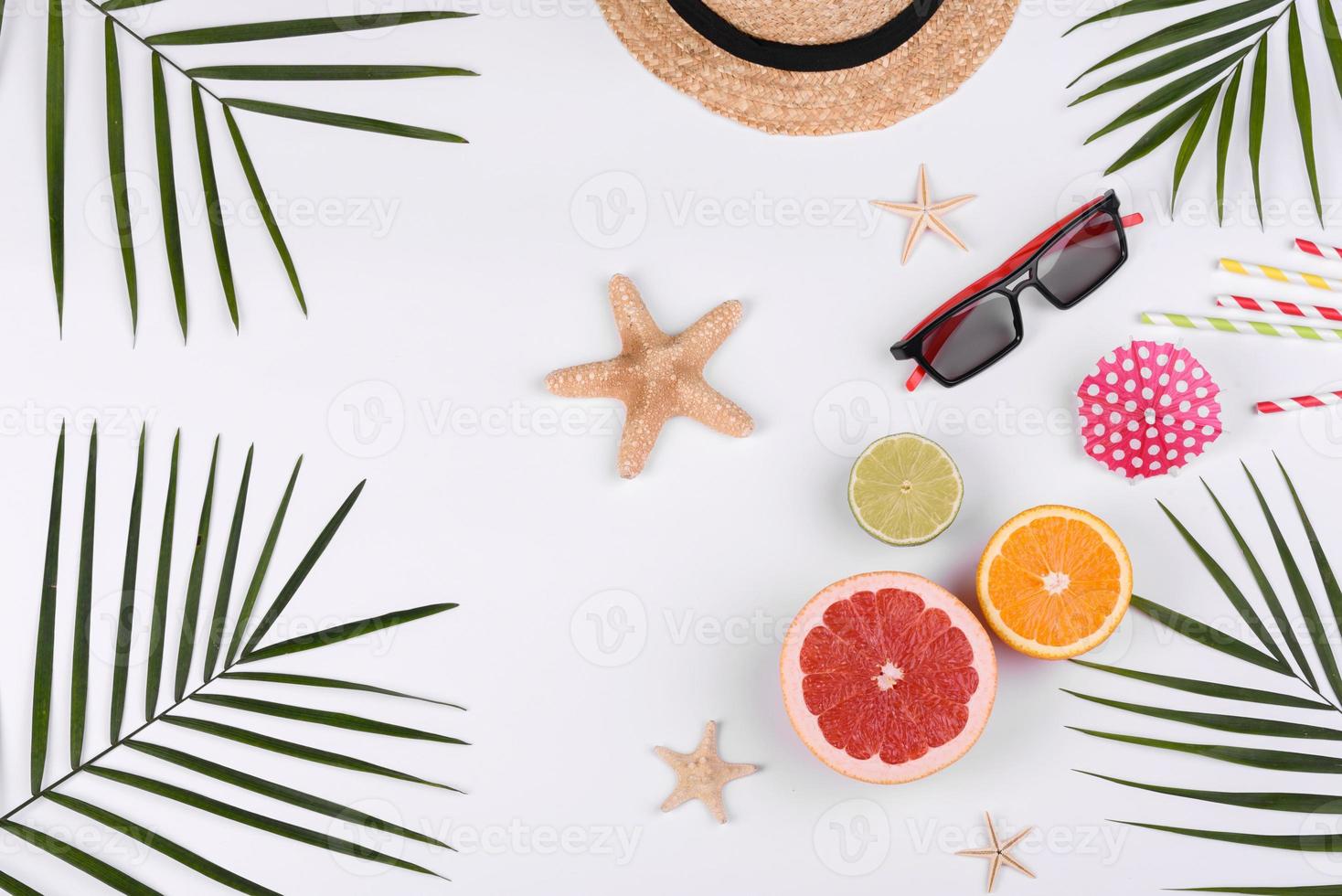 Beach accessories, glasses and hat with shells and sea stars on a colored background photo